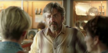 Movie still from “Sword of Trust” (2019), directed by Lynn Shelton – A person wearing glasses and a shirt; Close Up shot, Over the shoulder angle