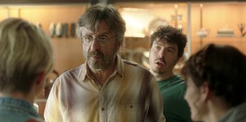 Movie still from “Sword of Trust” (2019), directed by Lynn Shelton – A man and a man standing next to each other in a room; Close Up shot, Over the shoulder angle