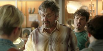 Movie still from “Sword of Trust” (2019), directed by Lynn Shelton – A man with a beard and glasses is looking at a camera; Close Up shot, Over the shoulder angle