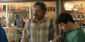 Movie still from “Sword of Trust” (2019), directed by Lynn Shelton – A man with a beard and glasses talking to another man; Medium shot, Over the shoulder angle