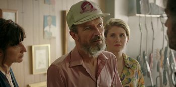 Movie still from “Sword of Trust” (2019), directed by Lynn Shelton – A man wearing a hat and a pink shirt; Close Up shot, Over the shoulder angle