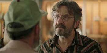 Movie still from “Sword of Trust” (2019), directed by Lynn Shelton – An older man wearing glasses talking to a younger man; Close Up shot, Over the shoulder angle