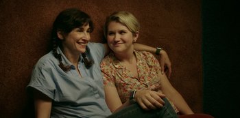 Movie still from “Sword of Trust” (2019), directed by Lynn Shelton – A couple of women sitting next to each other on top of a couch; Close Up shot, Overhead angle