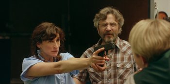 Movie still from “Sword of Trust” (2019), directed by Lynn Shelton – A man and a woman are holding a gun; Medium shot, Over the shoulder angle