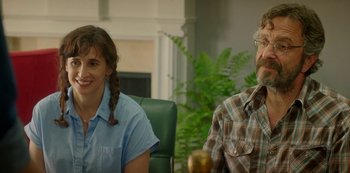 Movie still from “Sword of Trust” (2019), directed by Lynn Shelton – A man and a woman sitting in front of each other in a room; Medium shot, Over the shoulder angle