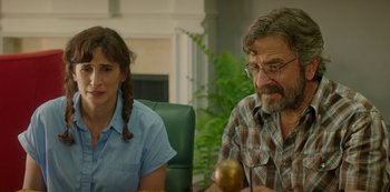 Movie still from “Sword of Trust” (2019), directed by Lynn Shelton – A man and a woman sitting at a table in a room; Medium shot, Over the shoulder angle