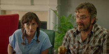 Movie still from “Sword of Trust” (2019), directed by Lynn Shelton – A man and a woman sitting next to each other in a room; Close Up shot, Over the shoulder angle