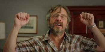 Movie still from “Sword of Trust” (2019), directed by Lynn Shelton – An older man with a beard and glasses is singing; Close Up shot, Low angle