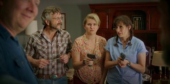 Movie still from “Sword of Trust” (2019), directed by Lynn Shelton – A group of people standing next to each other holding remotes; Medium shot, Over the shoulder angle