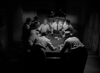 Movie still from “T-Men” (1947), directed by Anthony Mann – A group of men sitting around a table playing cards; Wide shot, High angle