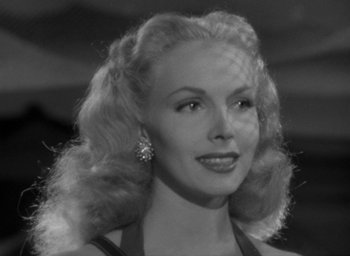 Movie still from “T-Men” (1947), directed by Anthony Mann – A black and white photo of a woman in a black dress; Close Up shot, Low angle