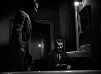 Movie still from “T-Men” (1947), directed by Anthony Mann – A man and a woman in a bathroom looking at each other; Medium shot, Over the shoulder angle