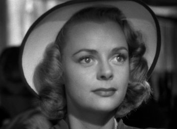 Movie still from “T-Men” (1947), directed by Anthony Mann – A black and white photo of a woman wearing a hat; Close Up shot, Low angle
