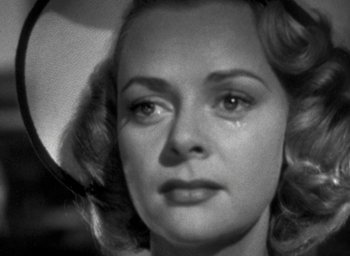 Movie still from “T-Men” (1947), directed by Anthony Mann – A person with a crying face; Close Up shot, Over the shoulder angle