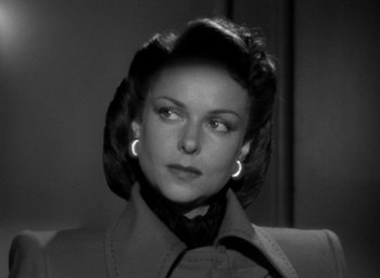 Movie still from “T-Men” (1947), directed by Anthony Mann – An old photo of a woman in a jacket; Close Up shot, Over the shoulder angle