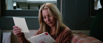 Movie still from “Table 19” (2017), directed by Jeffrey Blitz – A woman sitting in front of an open envelope; Close Up shot, Low angle