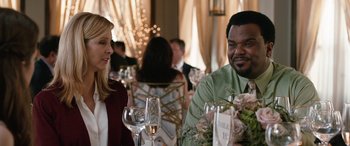 Movie still from “Table 19” (2017), directed by Jeffrey Blitz – A man and a woman sitting at a table with wine glasses; Medium shot, Over the shoulder angle