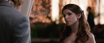 Movie still from “Table 19” (2017), directed by Jeffrey Blitz – A beautiful young lady in front of lights; Close Up shot, Over the shoulder angle