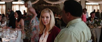 Movie still from “Table 19” (2017), directed by Jeffrey Blitz – A woman standing next to a man at a party; Close Up shot, Over the shoulder angle