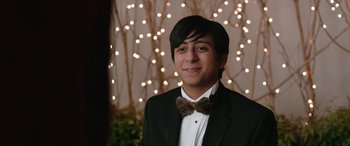 Movie still from “Table 19” (2017), directed by Jeffrey Blitz – A young man in a suit and bow tie; Close Up shot, Over the shoulder angle