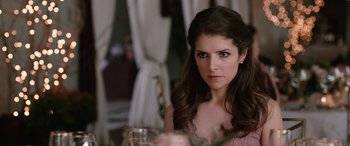 Movie still from “Table 19” (2017), directed by Jeffrey Blitz – A beautiful woman sitting at a table with a glass; Close Up shot, Over the shoulder angle