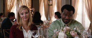 Movie still from “Table 19” (2017), directed by Jeffrey Blitz – A man and a woman sitting at a dinner table; Close Up shot, Over the shoulder angle