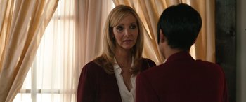 Movie still from “Table 19” (2017), directed by Jeffrey Blitz – A woman wearing a red jacket looking at a man; Close Up shot, Over the shoulder angle