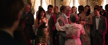 Movie still from “Table 19” (2017), directed by Jeffrey Blitz – A group of people standing in a room; Medium shot, Over the shoulder angle