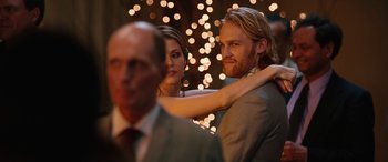 Movie still from “Table 19” (2017), directed by Jeffrey Blitz – A man and a woman dancing in front of some lights; Close Up shot, Over the shoulder angle