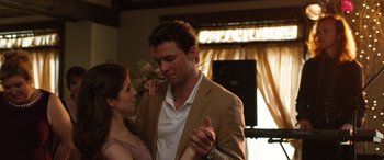 Movie still from “Table 19” (2017), directed by Jeffrey Blitz – A man and a woman dancing in front of a window; Medium shot, Low angle