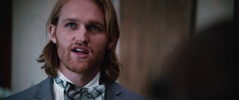 Movie still from “Table 19” (2017), directed by Jeffrey Blitz – A person wearing a suit and tie; Close Up shot, Over the shoulder angle