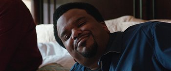 Movie still from “Table 19” (2017), directed by Jeffrey Blitz – A person smiling with his eyes closed; Close Up shot, Low angle