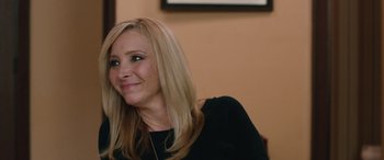 Movie still from “Table 19” (2017), directed by Jeffrey Blitz – A woman with blonde hair sitting at a table; Close Up shot, Over the shoulder angle