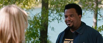 Movie still from “Table 19” (2017), directed by Jeffrey Blitz – A man standing in front of a body of water; Close Up shot, Over the shoulder angle