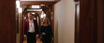 Movie still from “Table 19” (2017), directed by Jeffrey Blitz – A man and a woman walking down a hall way; Medium shot, Over the shoulder angle