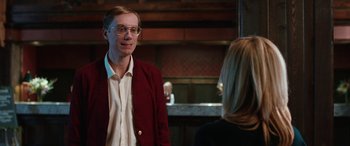 Movie still from “Table 19” (2017), directed by Jeffrey Blitz – A man in a red jacket talking to a woman in a white shirt; Medium shot, Over the shoulder angle