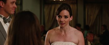 Movie still from “Table 19” (2017), directed by Jeffrey Blitz – A beautiful woman in a white dress looking at the camera; Close Up shot, Over the shoulder angle