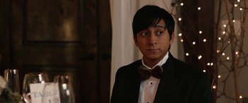 Movie still from “Table 19” (2017), directed by Jeffrey Blitz – A man in a suit and a bow tie; Close Up shot, Over the shoulder angle