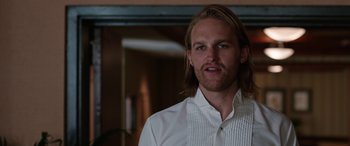 Movie still from “Table 19” (2017), directed by Jeffrey Blitz – A person with long hair wearing a white shirt; Close Up shot, Low angle