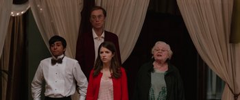 Movie still from “Table 19” (2017), directed by Jeffrey Blitz – A group of people standing next to each other in a room; Medium shot, Over the shoulder angle