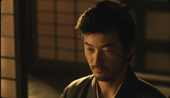 Movie still from “Taboo” (1999), directed by Nagisa Ôshima – A person wearing a robe; Close Up shot, Over the shoulder angle