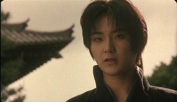 Movie still from “Taboo” (1999), directed by Nagisa Ôshima – A young man with short black hair is looking at the camera; Close Up shot, Low angle
