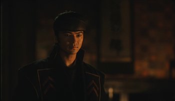 Movie still from “Taboo” (1999), directed by Nagisa Ôshima – A man in a hat and jacket is looking at the camera; Close Up shot, Over the shoulder angle