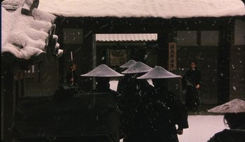 Movie still from “Taboo” (1999), directed by Nagisa Ôshima – A group of people wearing hats in the snow; Wide shot, High angle