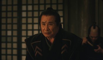 Movie still from “Taboo” (1999), directed by Nagisa Ôshima – An older man wearing a black robe looking at the camera; Close Up shot, Low angle