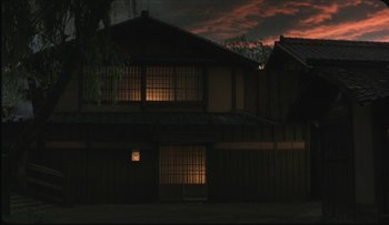 Movie still from “Taboo” (1999), directed by Nagisa Ôshima – A house that is lit up at night time; Extreme Wide shot, Low angle