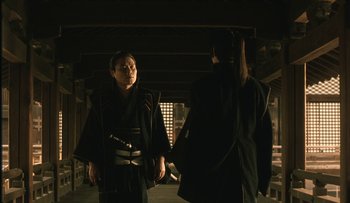 Movie still from “Taboo” (1999), directed by Nagisa Ôshima – A man and a woman dressed in traditional japanese garb; Medium shot, Over the shoulder angle