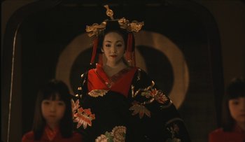 Movie still from “Taboo” (1999), directed by Nagisa Ôshima – A geisha in a black and red kimono; Close Up shot, Over the shoulder angle