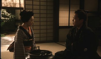 Movie still from “Taboo” (1999), directed by Nagisa Ôshima – Two people sitting in a room talking to each other; Medium shot, Over the shoulder angle