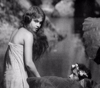 Movie still from “Tabu: A Story of the South Seas” (1931), directed by F.W. Murnau – A young girl is standing next to a young girl; Medium shot, High angle
